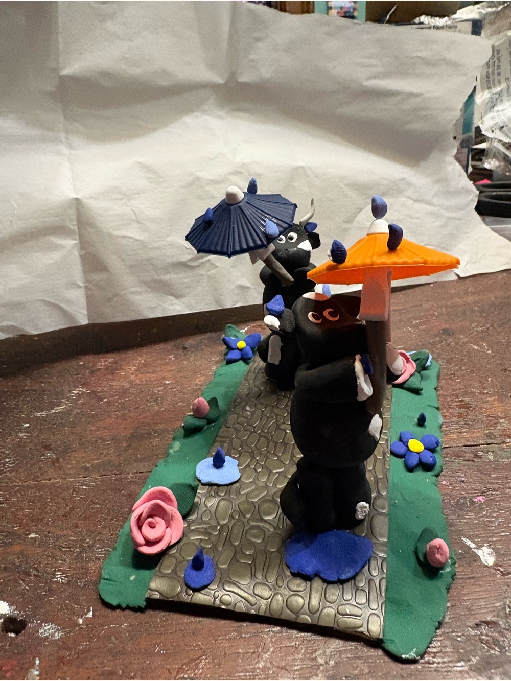 Handmade Cow Figurine Garden Scene with Orange & Blue Umbrella
